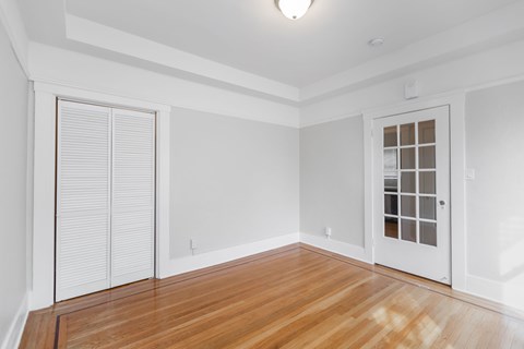 A room with a wooden floor and white walls.