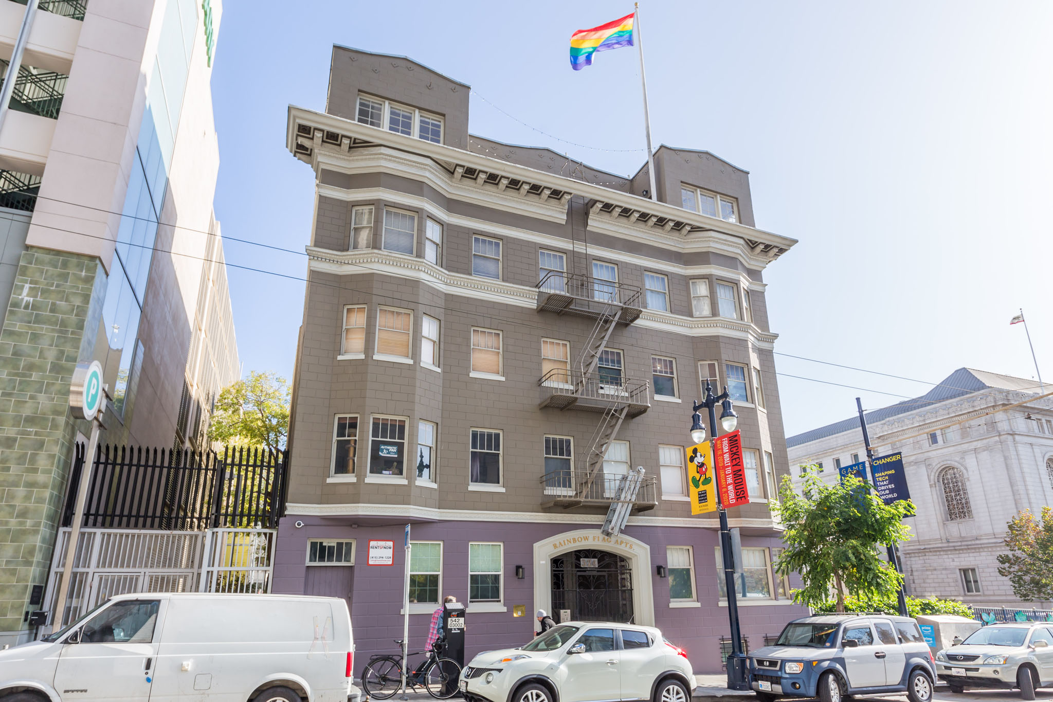 A building with a rainbow flag on top of it.