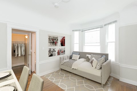 a living room with a couch and a door to a closet