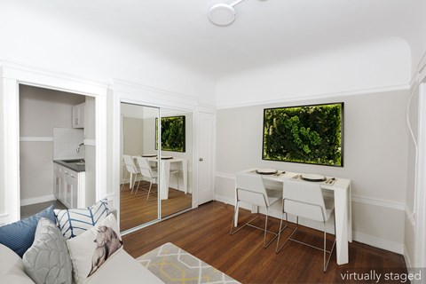A white dining room with a table and chairs.