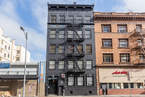 A tall building with a fire escape on the side.