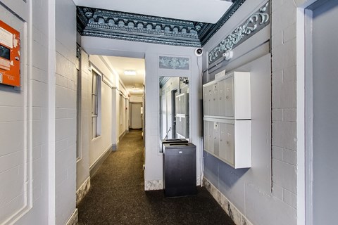 A long hallway with a trash can in the middle.