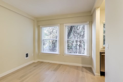 A room with a window covered in blinds.