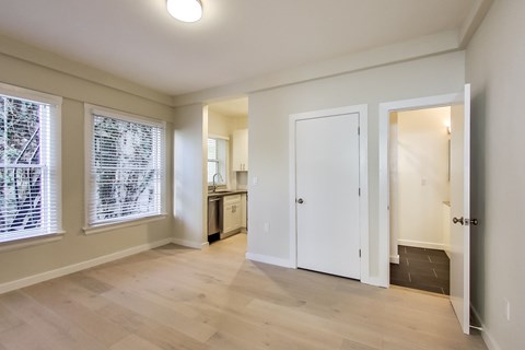 A room with a white door and a white cabinet.