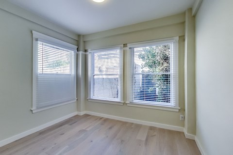 A room with a window and blinds.