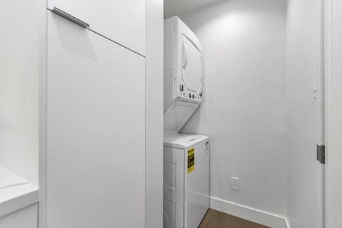 A white refrigerator is in a small kitchen.