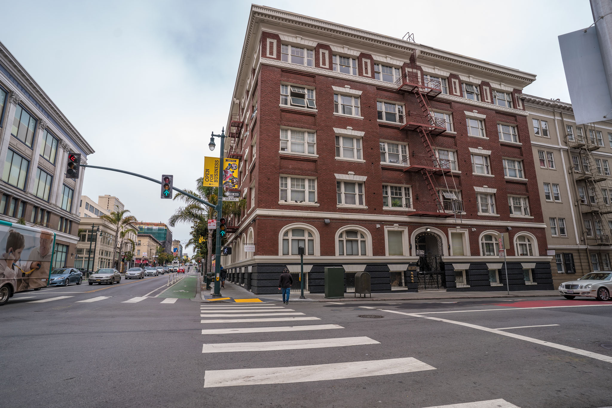 A large red brick building with a fire escape on the side.