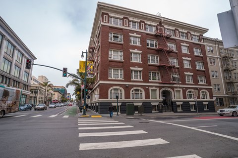 A large red brick building with a fire escape on the side.