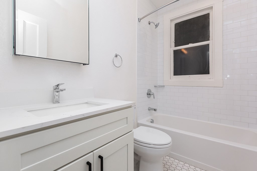 a white bathroom with a sink and a toilet