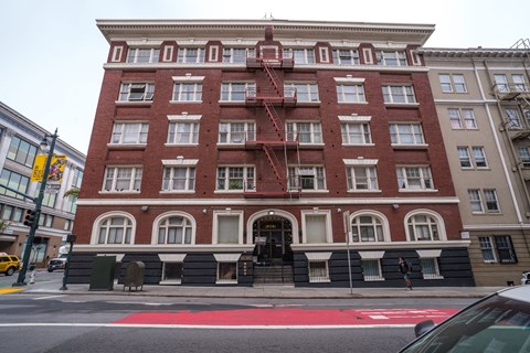 A red brick building with a fire escape on the side.