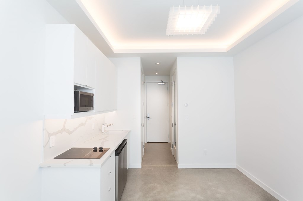a white kitchen with white cabinets and a white counter top