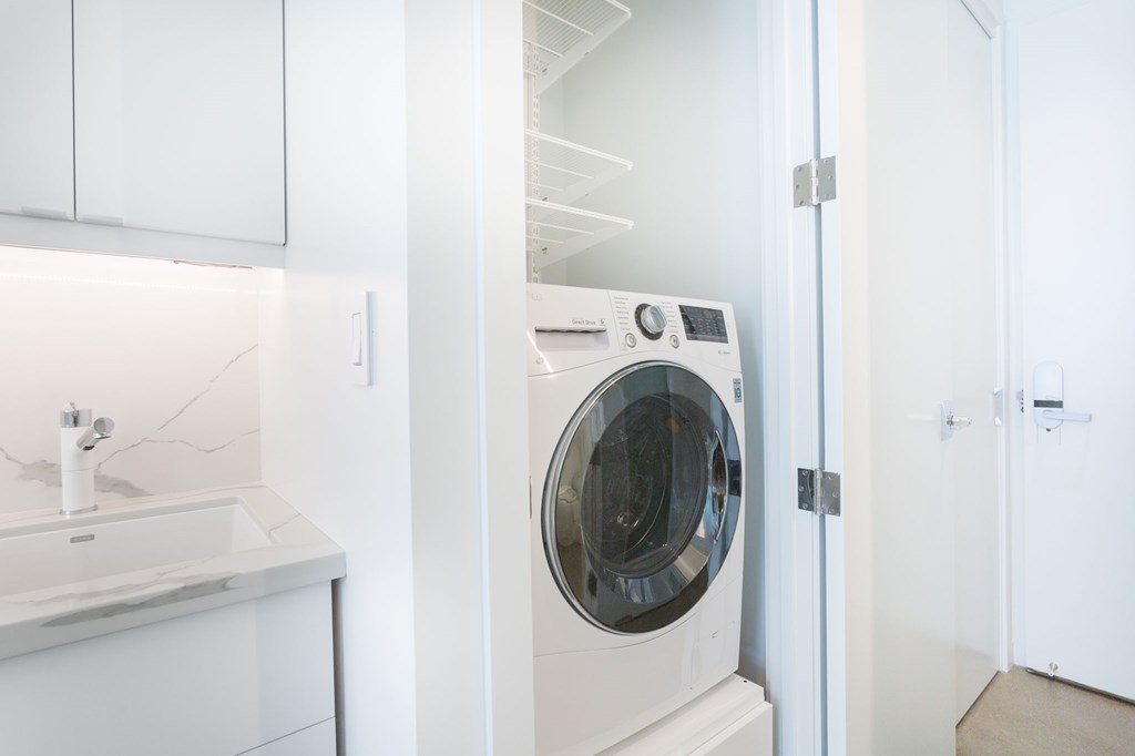 a white washer and dryer in a small laundry room