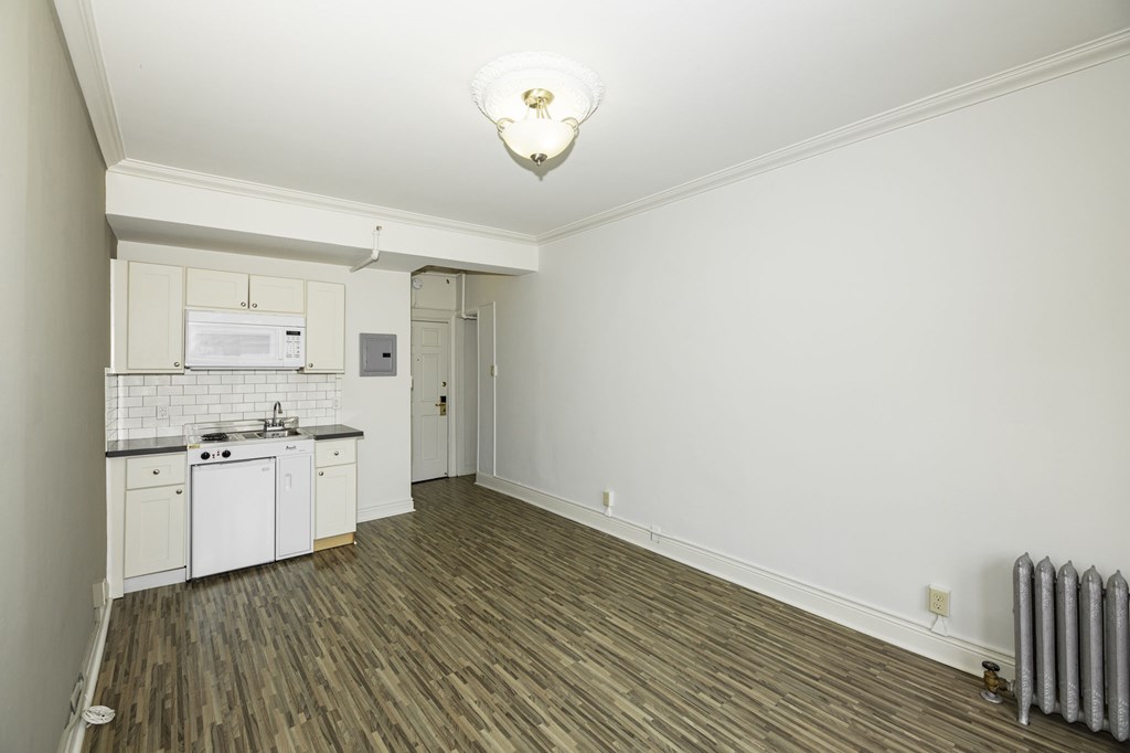 a kitchen with white cabinets and a stove and a sink