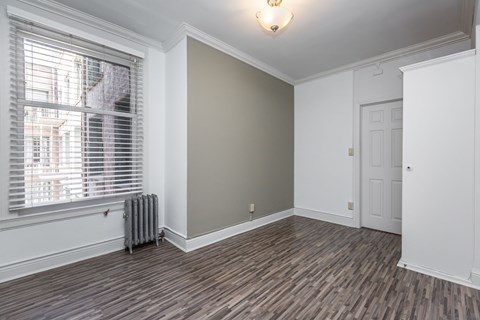 A room with a window and a radiator.