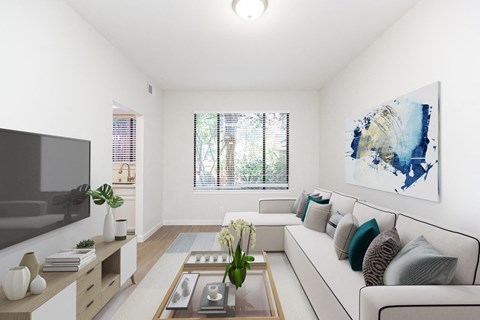 A living room with a white couch, a flat screen TV, a coffee table, and a painting on the wall.
