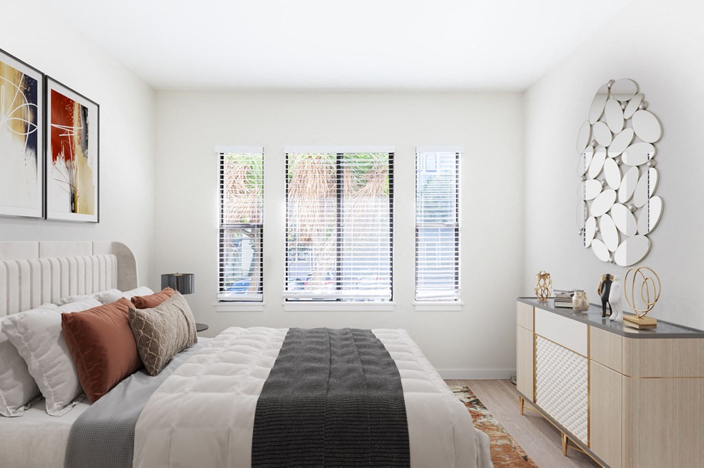 A bedroom with a large bed and a mirror on the wall.