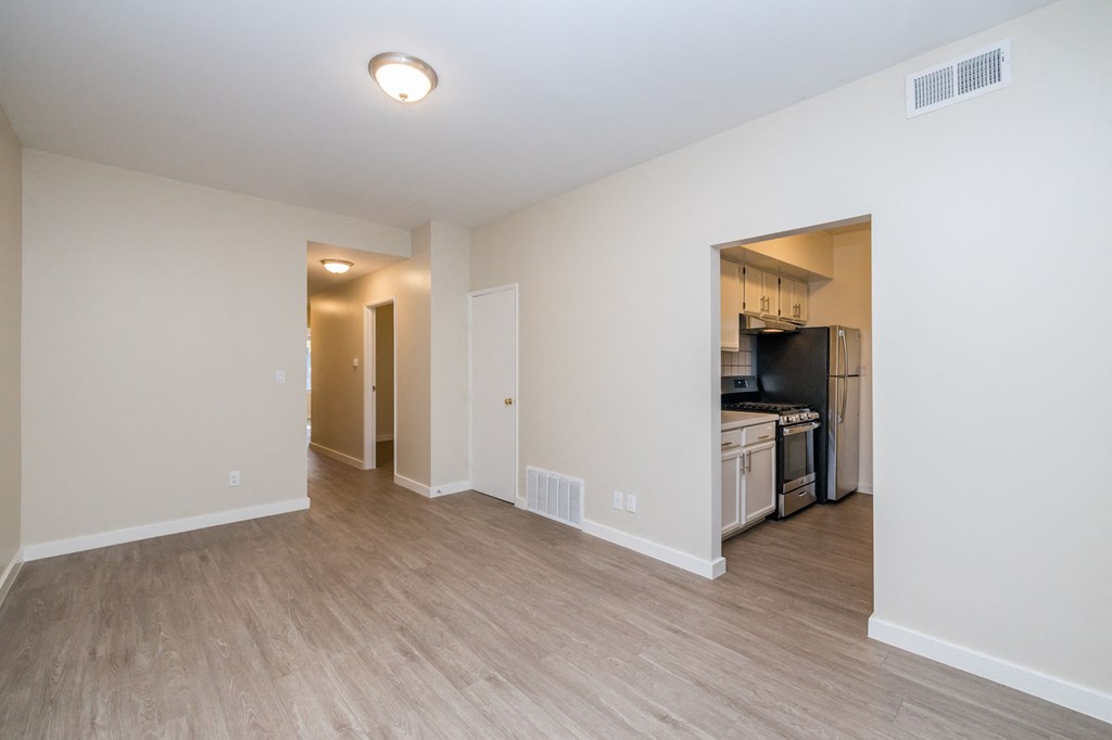 A kitchen area with a refrigerator, oven, and microwave.