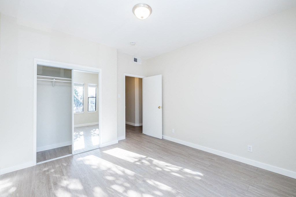 A white room with a door and a window.