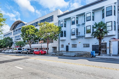 A red car is parked on the side of the street.