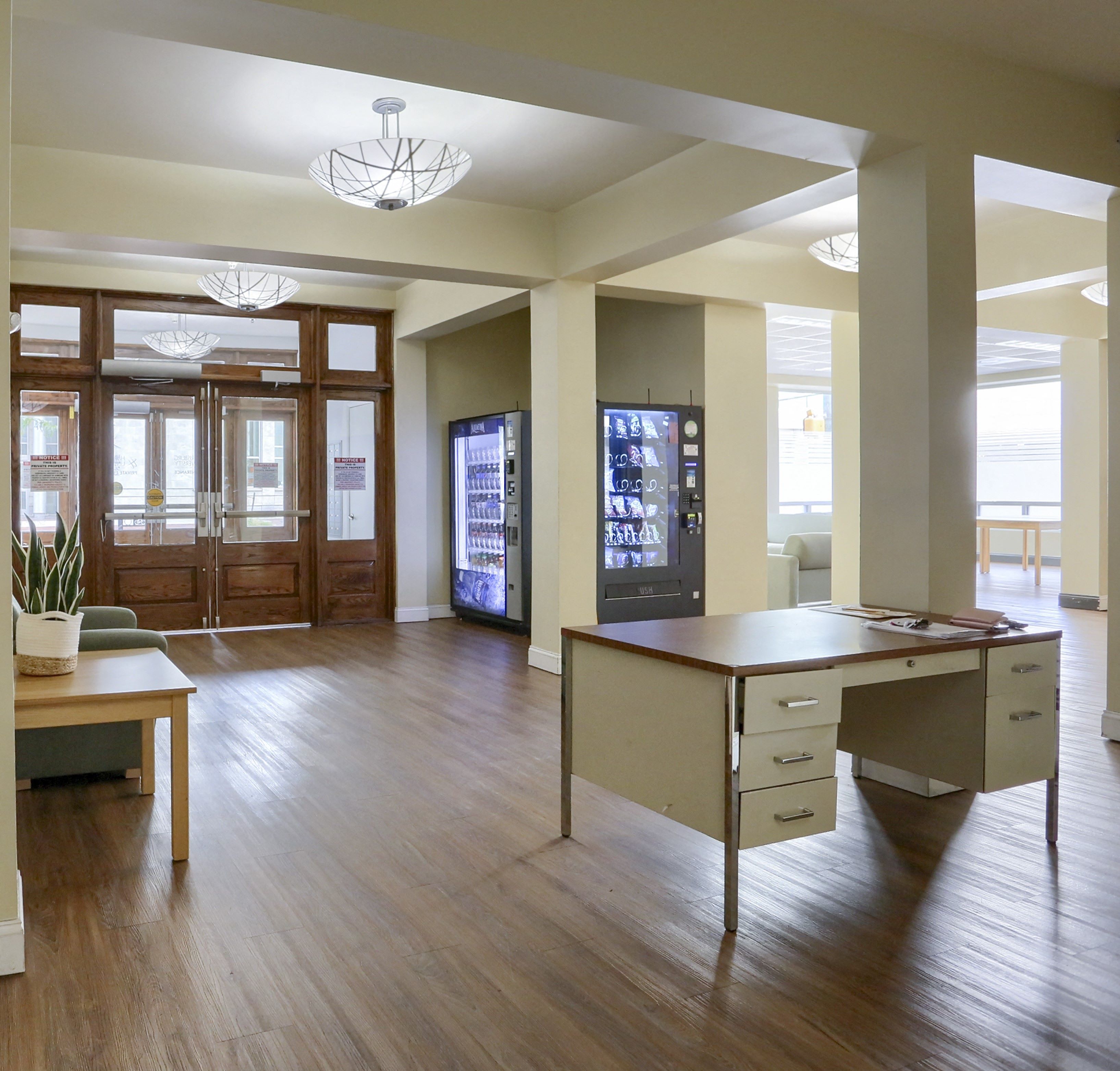 an empty office space with a desk and a table