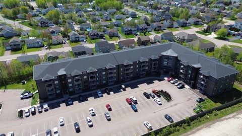 A parking lot in front of a large building.
