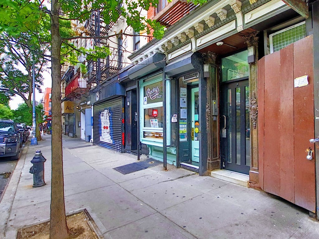 a city street with shops and a fire hydrant