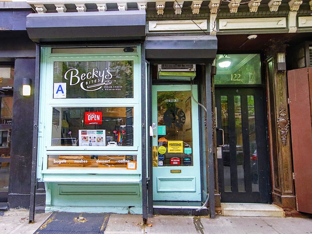 the front of a store with a blue door