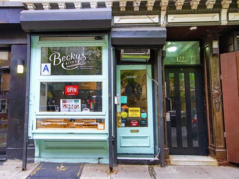 the front of a store with a blue door