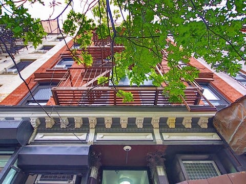 a view of a building with a balcony from the street
