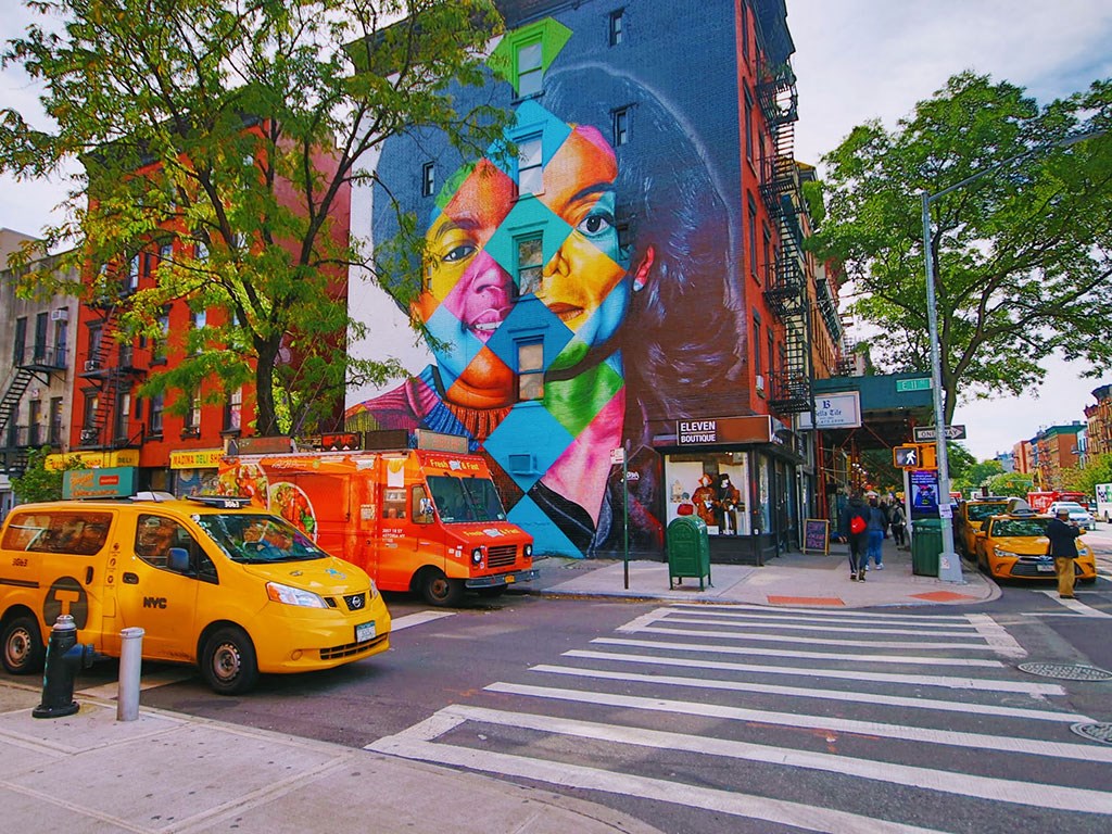 a mural on the side of a building on a city street