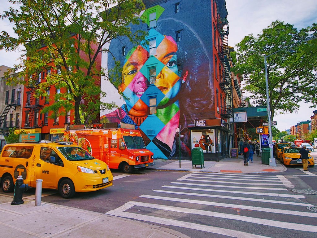 a mural on the side of a building on a city street