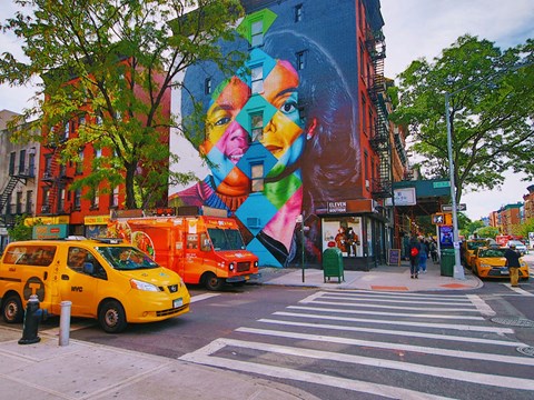 a mural on the side of a building on a city street