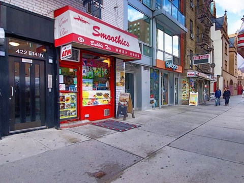 a supermarket with a red and white sign on a sidewalk