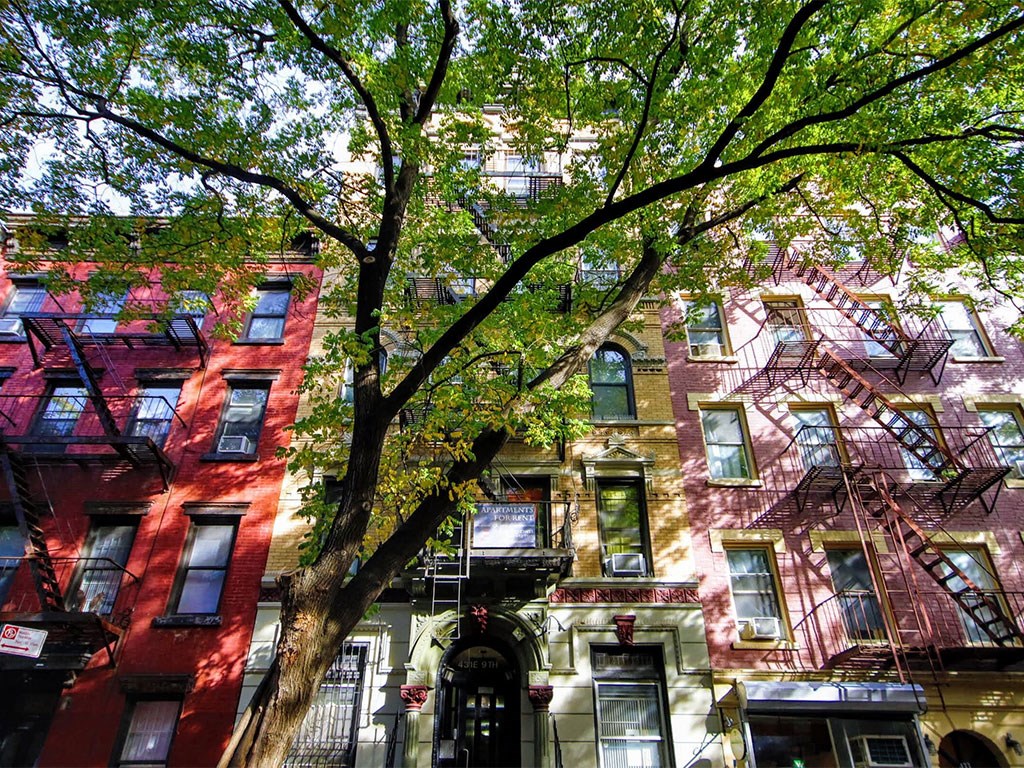 a group of buildings with trees in front of them
