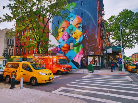 a mural on the side of a building on a city street