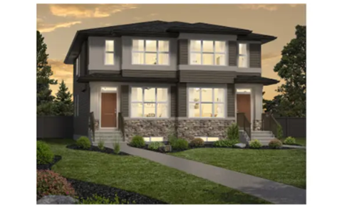 A modern house with a front yard and a stone wall.