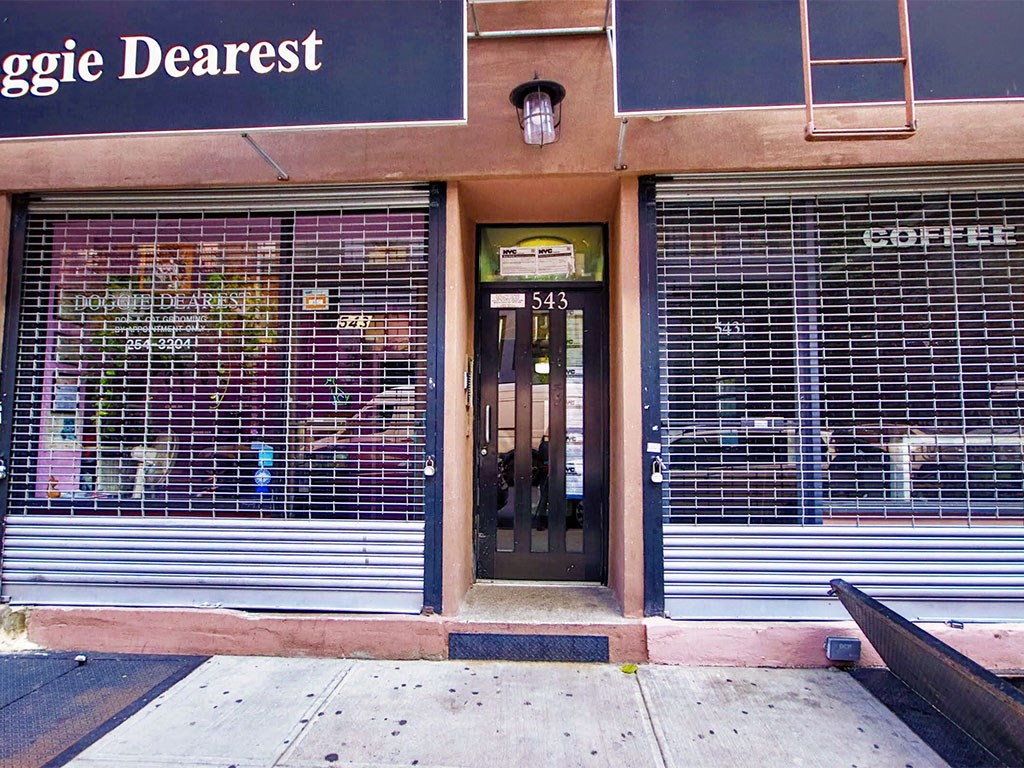 the front of a coffee shop with closed doors