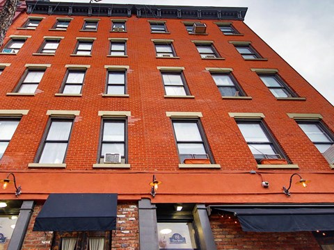 a tall red brick building with many windows
