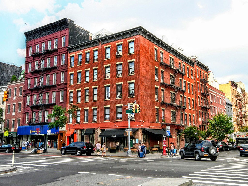 a red brick building on the corner of a city street