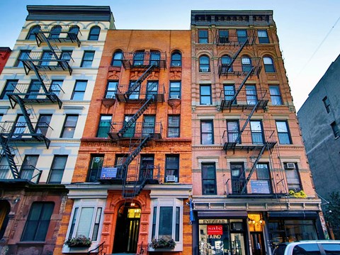 a building with a fire escape on the side of a street