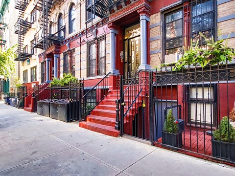 a red staircase in front of a red brick building