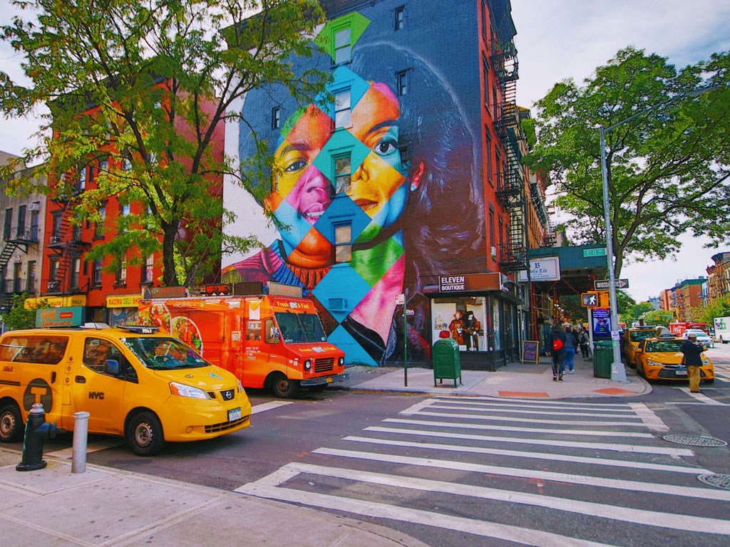a mural on the side of a building on a city street