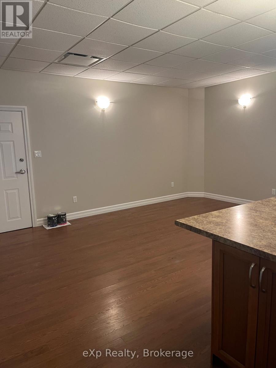 A room with a white door and a brown counter.