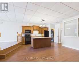 A room with a white door and a brown counter.