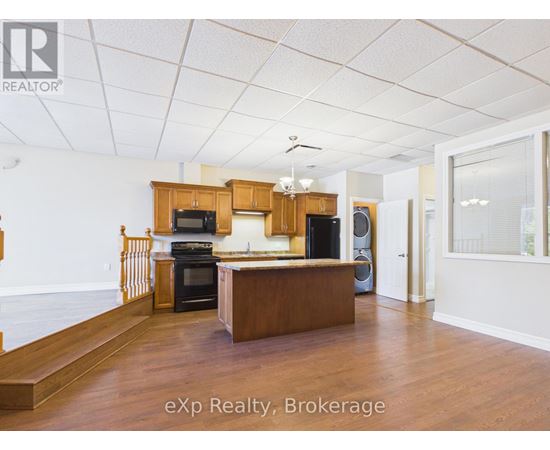 A room with a white door and a brown counter.