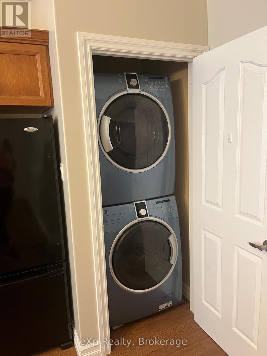 A washer and dryer are stacked in a small space.