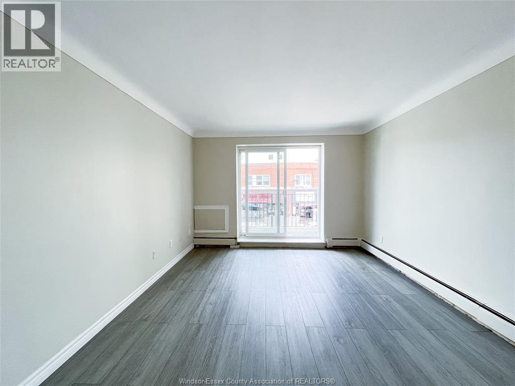 A spacious room with a view of a building outside the window.
