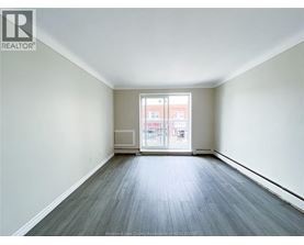 A spacious room with a view of a building outside the window.