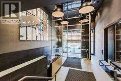 A modern interior space with a glass wall and a black and white color scheme.