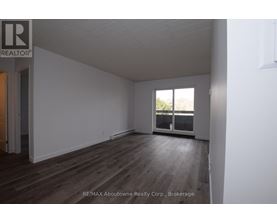 A room with a window and wooden flooring.